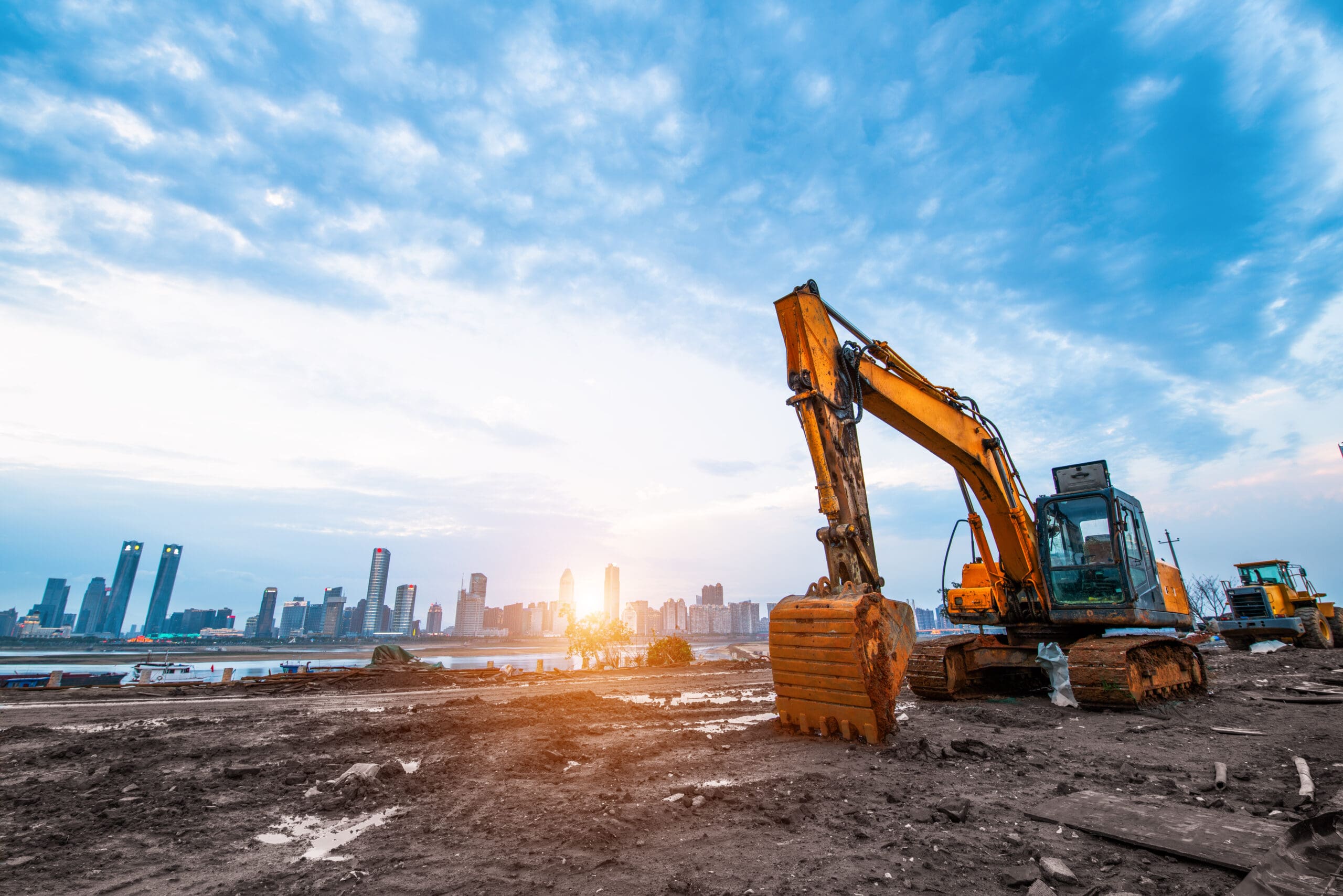 Excavator,In,Construction,Site,On,Sunset,Sky,Background