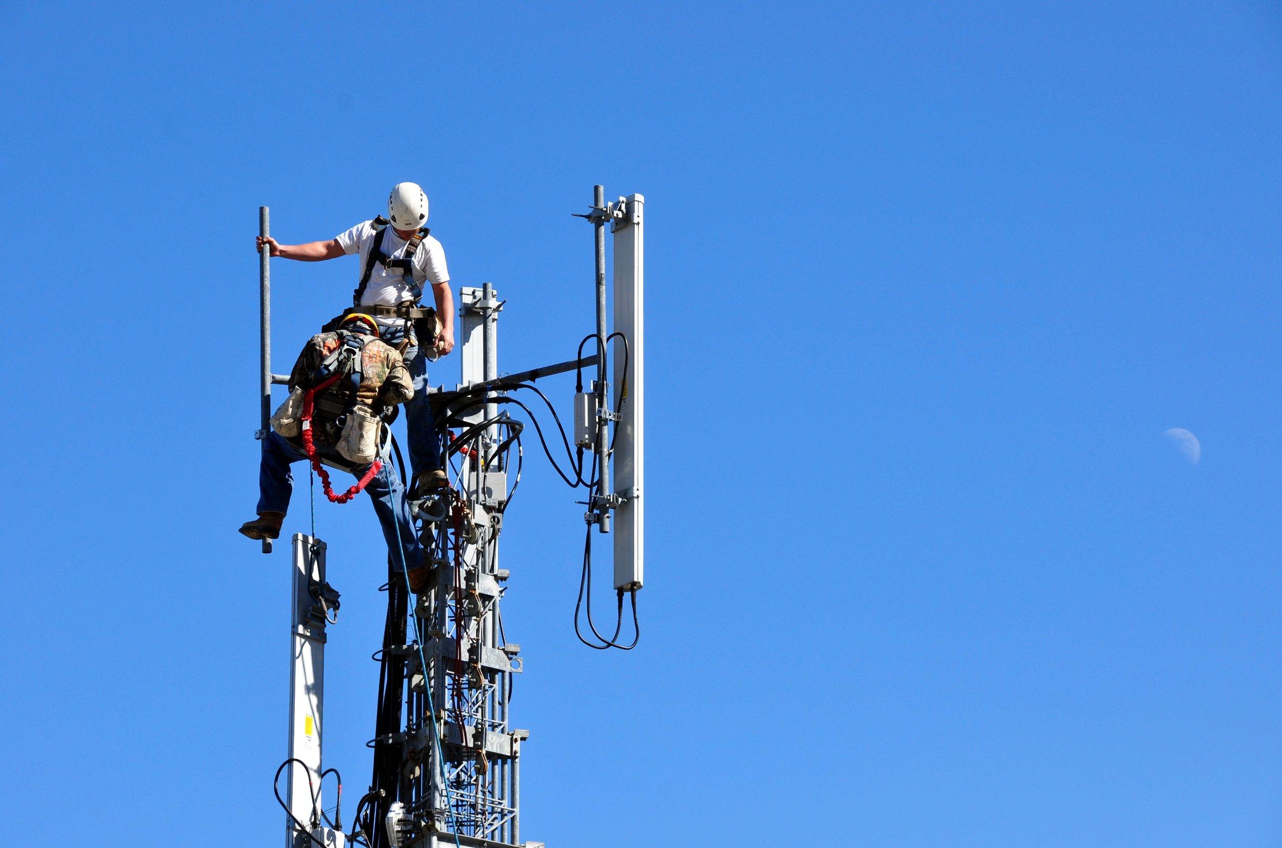 Two,Men,Working,On,A,Telecommunication,Tower